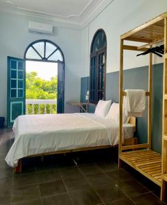 a bedroom with a bed and a window at Hanoi AVANA HOMESTAY LONG BIEN in Hanoi