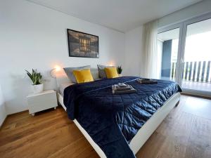 Dormitorio con cama con edredón azul y almohadas amarillas en Luxuriöses 130qm Apartment mit Balkon im Zentrum,Parkplatz, en Heilbronn