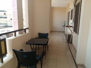 a room with chairs and a table and a window at HEBERTOGO TOKOIN CASABLANCA in Lomé