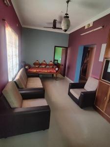 a living room with two couches and a couch at La Maison Renald in Pondicherry