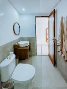 a bathroom with a toilet and a sink at Sanubari Ubud in Ubud