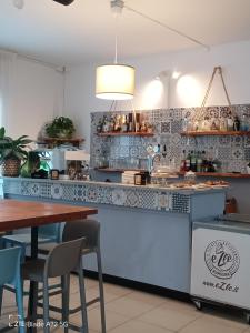 a kitchen with a table and chairs and a counter at Ninfea rooms in Cervia +21 photos