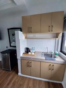a kitchen with a sink and a counter top at Regal425 Condotel in Angeles