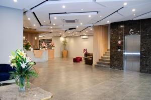 a lobby with a reception desk and a lobby sidx sidx sidx sidx at Arcadia Hotel Manado in Manado