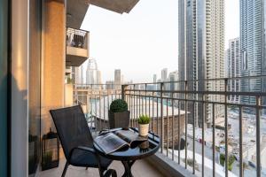 a balcony with a table and a view of a city at Ultimate Stay 2 BR Next to Burj Khalifa with Opera & Fountain Views in Dubai +47 photos