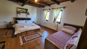 a bedroom with a bed and a couch in it at Casa bunicilor din Oncești in Onceşti +24 photos