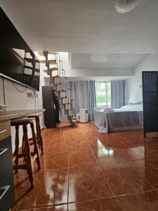 a room with a kitchen and a bedroom with a bed at Captain Morgan House in Arona