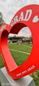 a large red heart sculpture in front of a soccer field at Restoran Domaćin in Bosanski Novi