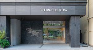 a building with a sign that reads the knot higginsuminati at THE KNOT HIROSHIMA in Hiroshima
