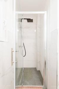 a shower with a glass door in a bathroom at Apartman JAM in Solin