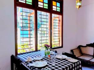 einen Tisch mit einem schwarz-weißen karierten Tischtuch in der Unterkunft Green Shade Resort & Haritha Sewana Hotel in Nallathanniya