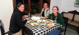 a group of people sitting at a table eating food at Green Shade Resort & Haritha Sewana Hotel in Adams Peak