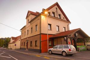 a car parked in front of a building on a street at LAAS ART GALLERY in Stari Trg pri Ložu
