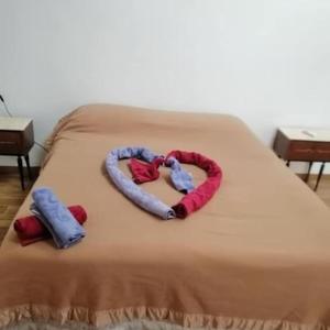a bed with a heart made out of towels at Casa Bosco in San Polo