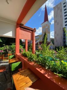 a balcony with tables and a view of a church at ChocoHouse in Hue