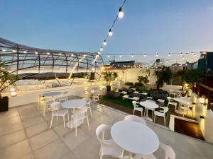 a rooftop patio with tables and chairs on a building at Aurora Suites in Manila