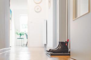 a pair of shoes sitting on the floor in a hallway at Casa Ueberall in Fehmarn +29 photos