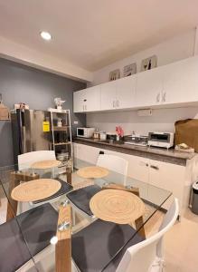 a kitchen with a table and chairs and a counter at Charm’s Place in Olongapo +3 photos