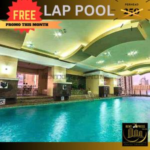 a large swimming pool in a hotel with a sign that reads lap pool at FREE SAUNA & POOL ACCESS PLUS 70 PERCENT LESS PROMO This Month Affordable And Cheapest Deluxe Unit In Manila with Balcony x Near NAIA Airport x Manila Bay x Robinsons Place Ermita x Pgh x Bellagio x UP x Intramuros x Updated 2024 Price Staycation in Manila