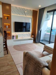 a living room with a flat screen tv on a wall at 902 Hareta Serviced Apartment in Phnom Penh