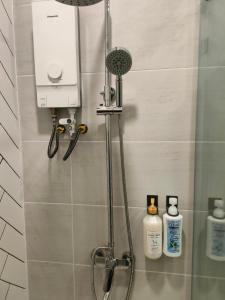 a shower with a shower head and a shower at 902 Hareta Serviced Apartment in Phnom Penh