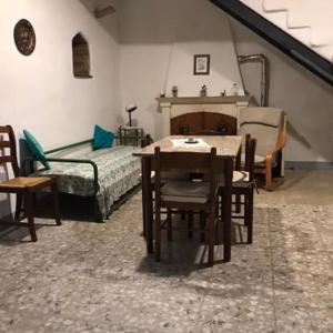 a room with a table and chairs and a bed at Casa della Luna in Tarano