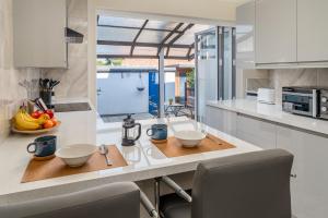 a kitchen with a counter with bowls on it at Homely and Stylish Apartment with a garden in East Finchley in London