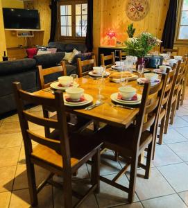 a wooden dining room table with chairs and a tableastery at Chalet Les Lanchettes in Morzine