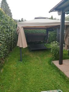 a gazebo with an umbrella on the grass at durbuy intimité vintage in Durbuy