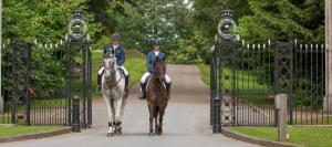 two people riding horses in front of a gate at Delightful Devon Cottage in East Budleigh