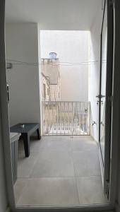 a view from an open door of a room with a balcony at Seaside Apartment in Gzira in Il-Gżira