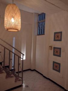 a room with a staircase and a chandelier at Buganviles 16, !Pura Vida! in Girardot +2 photos