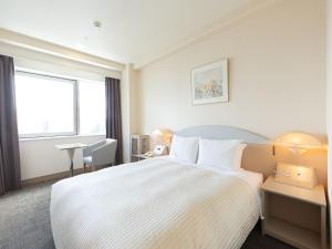 Postel nebo postele na pokoji v ubytování Kawagoe Prince Hotel