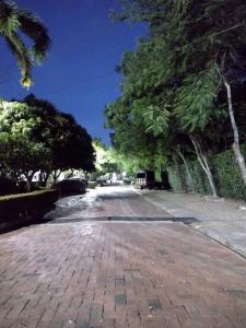 a brick road with trees on the sides of it at Buganviles 16, !Pura Vida! in Girardot
