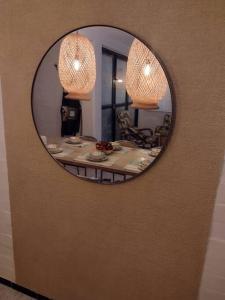 a mirror on a wall with a table in a room at Buganviles 16, !Pura Vida! in Girardot