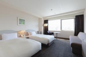 Postel nebo postele na pokoji v ubytování Kawagoe Prince Hotel