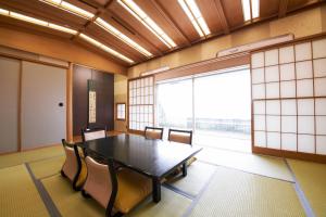 a conference room with a table and chairs and a large window at Kawagoe Prince Hotel in Kawagoe