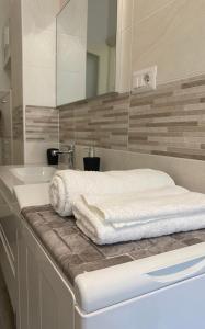 a bathroom with white towels sitting on a counter at ToPlay! in Turin