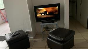 uma sala de estar com uma televisão e um banco em Céntrico y amoblado en Arica em Arica