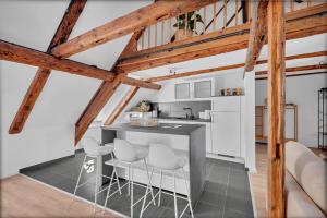 a kitchen with white walls and wooden beams at Einzigartig - Schlossblick - Maisonette - Smart TV in Wernigerode