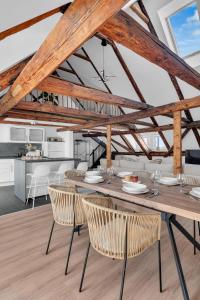 a dining room and kitchen with a wooden table and chairs at Einzigartig - Schlossblick - Maisonette - Smart TV in Wernigerode