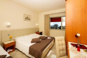 Postel nebo postele na pokoji v ubytování Hotel Nuova Sabrina