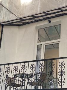 a balcony with a wrought iron railing and a window at Soli Lviv in Lviv