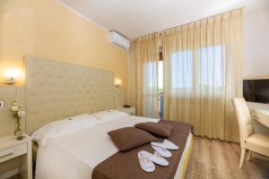 Postel nebo postele na pokoji v ubytování Hotel Nuova Sabrina