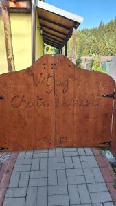 a wooden gate with writing on it at Chata Daniela in Liptovská Osada
