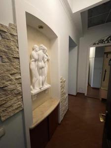 a museum with two statues on a wall at Prestige in Lviv