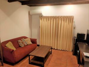 a living room with a couch and a coffee table at Kunigami-gun - Hotel / Vacation STAY 11195 in Onna +1 photo