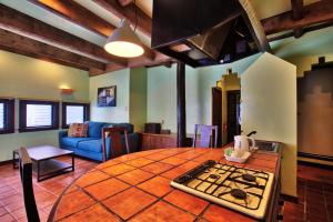 a living room with a table and a stove in a room at Kunigami-gun - Hotel / Vacation STAY 11195 in Onna