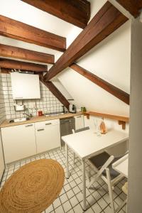 a kitchen with wooden ceilings and a white table at Feierabend im Grünen in Haan