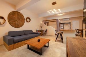 a living room with a couch and a table at Andros 4 All Seasons Villas & Suites in Andros